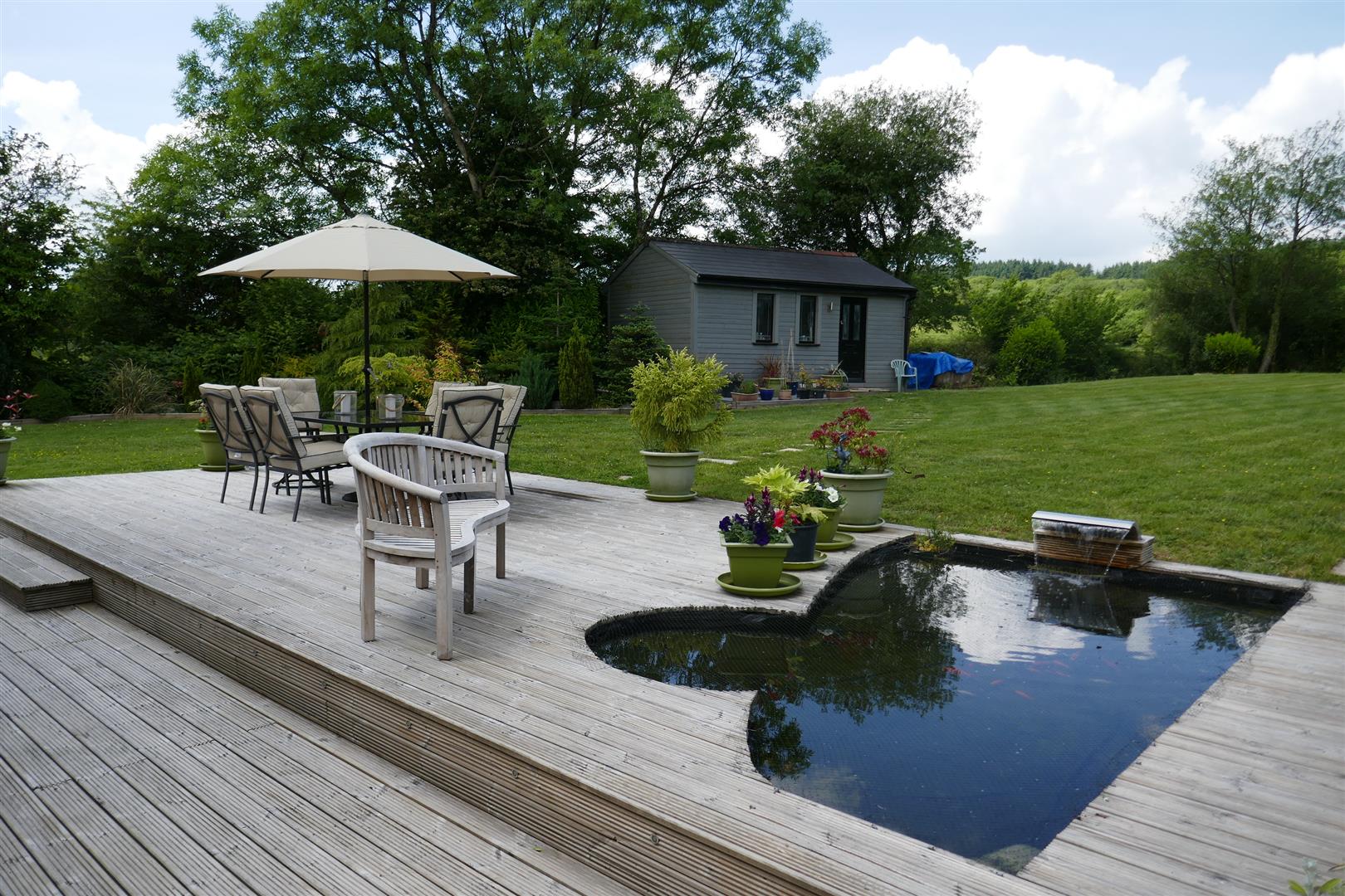 DECKED PATIO AND FISH POND